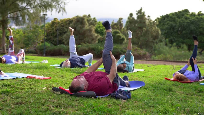 Group of senior people doing yoga stretching exercise at city park - Fit healthy elderly community and sport concept  - Powered by Shutterstock - Get 15% off with code: PIKWIZARD15