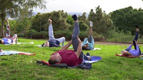 Group of senior people doing yoga stretching exercise at city park - Fit healthy elderly community and sport concept  - Powered by Shutterstock - Get 15% off with code: PIKWIZARD15