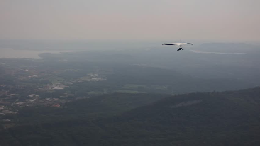 Laveno Mombello, Varese, Italy - September 1, 2024: Hang glider and paraglider in flight at Poggio Sant