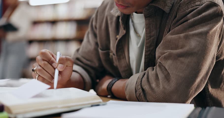 Student, writing and books with hands of man in library for knowledge, education and college thesis. Academy, future and university with person and studying for exam, project and scholarship