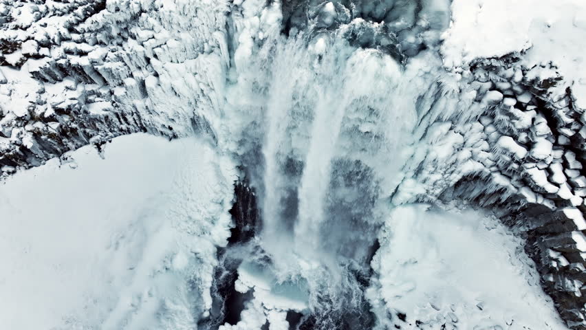 Waterfall in Iceland, Frozen river in winter, Magical location of snow and ice, Magical winter landscape in the northern country, Svodufoss