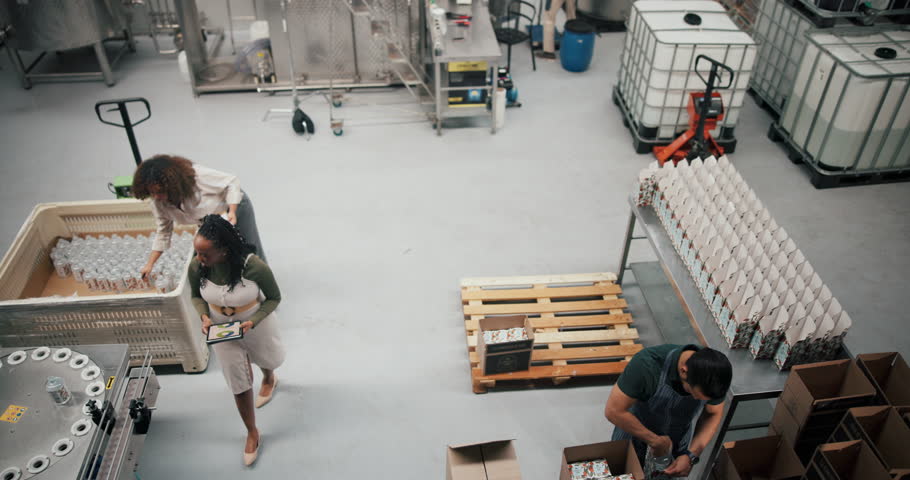 Women, employees and tablet for stocktaking at distillery for alcohol manufacturing and production. People, supervisor and above with teamwork or collaboration at factory for gin supply with machines