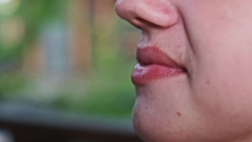 Close-up of a child drinking soda from a plastic bottle, highlighting the issue of unhealthy beverage choices and their potential impact on child health and well-being.