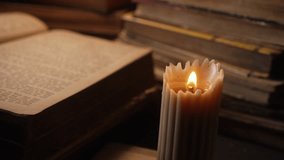 Man reading old book under wax candlelight in library. Middle-ages authentic cozy room. Candle burning. Literature promotions or tranquil visual storytelling - Powered by Shutterstock - Get 15% off with code: PIKWIZARD15