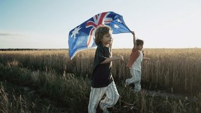 Australian little boys - sons patriots with national flag on sky background at sunset. Australia celebration banner, Anzac day, commonwealth - Powered by Shutterstock - Get 15% off with code: PIKWIZARD15