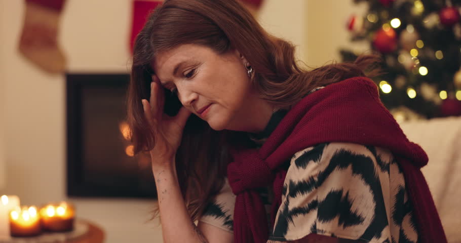 Stress, thinking and woman in Christmas, sad and lonely in house, unhappy and broke for celebration. Home, contemplating and mature person with migraine, anxiety and burnout of season and holiday