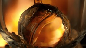Super Slow Motion Detail Shot of Pouring Whiskey on Ice Sphere in Glass at 1000fps. - Powered by Shutterstock - Get 15% off with code: PIKWIZARD15