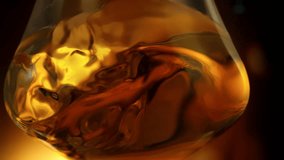 Super Slow Motion Detail Shot of Swirling Golden Alcohol in Glass at 1000fps. - Powered by Shutterstock - Get 15% off with code: PIKWIZARD15