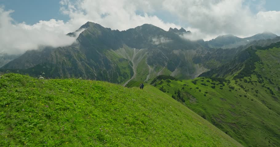 A couple hikes through lush green hills with stunning mountain views in Berwang, Austria