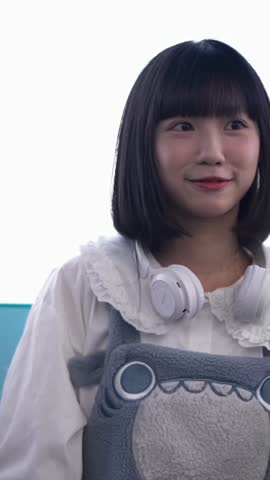 A young Taiwanese woman in her 20s is riding a Ferris wheel, taking pictures, and listening to music while on a date at an amusement park in Shilin District, Taipei City, Taiwan. Vertical video.