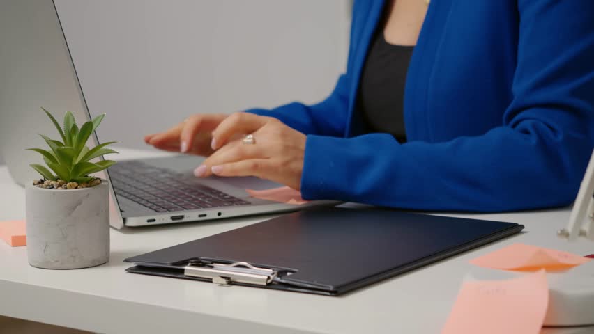 Woman in an Office Setting Opening a Folder and Flipping Through Euro Bills to Count Them, Managing Business Finances, Handling Cash, and Organizing Monetary Resources for Accurate Record Keeping