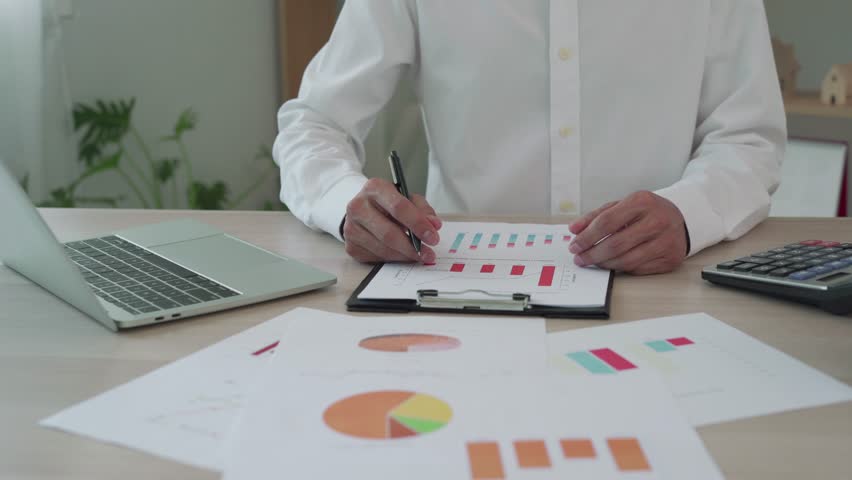 Business Owners Checking Their Monthly Financial Results, Reviewing Invoices, Sales, and Profit Margins to Assess the Success of Their Business and Make Informed Decisions for Future Growth