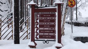 Directional signpost covered with snow, Santa Claus Village - Powered by Shutterstock - Get 15% off with code: PIKWIZARD15