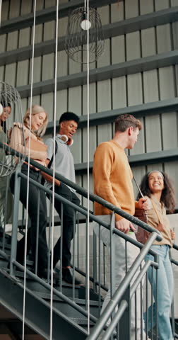 Walking, friends and students on stairs at university for talking, conversation and chat on campus. College, academy and happy men and women on steps to class for learning, education and studying