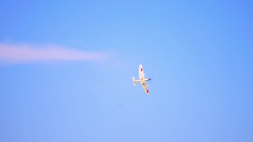 Supermarine Spitfire WWII fighter aircraft performing an aerial maneuver. The aircraft features distinctive Czech Air Force markings, showcasing its historical role during and after World War II.