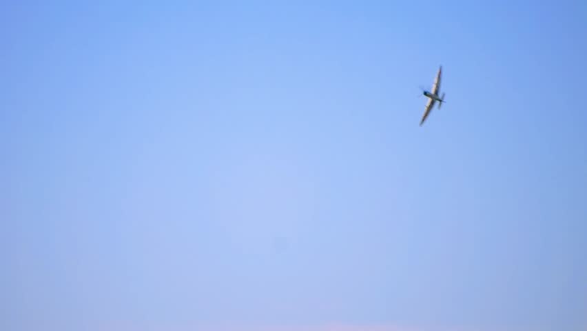 Supermarine Spitfire performs thrilling aerial maneuver, with Czech Air Force marking. WWII-era fighter aircraft in mid-flight, showcasing agility and historical significance in wartime aviation