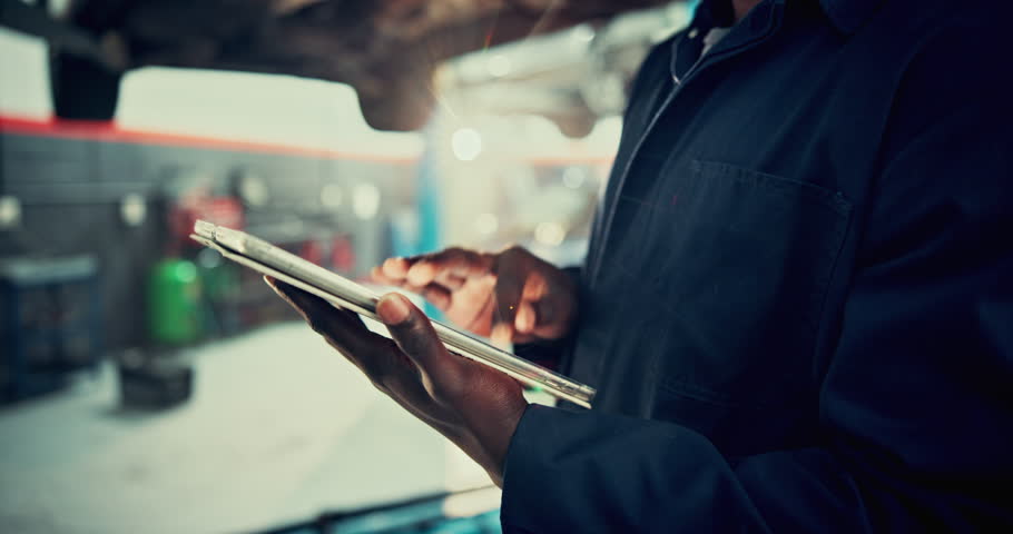 Mechanic, tablet and hand with man and car in auto repair shop for diagnostic test, transport or calibration. Engineer, maintenance or motor technician with person in garage for inspection report
