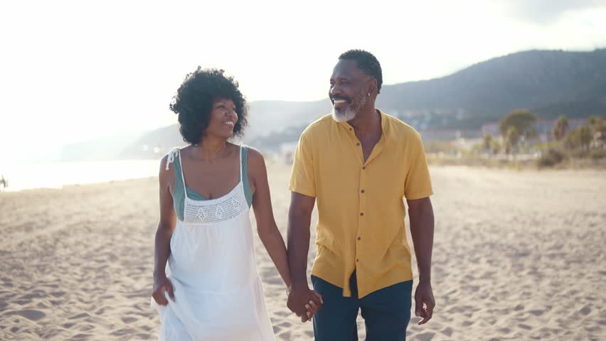 Cinematic video of an happy latin senior couple spending time at the beach. Concept  about seniority and lifestyle