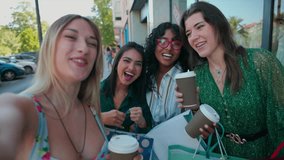A group of multiracial women take a video selfie with their smartphone after shopping on Black Friday, holding coffee and shopping bags.  - Powered by Shutterstock - Get 15% off with code: PIKWIZARD15