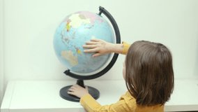 Child  with globe. Svhool girl learns about countries. Education concept. - Powered by Shutterstock - Get 15% off with code: PIKWIZARD15