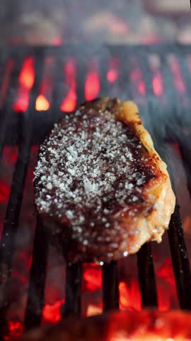 beef entrecote with coarse salt cooking on the grill in a restaurant