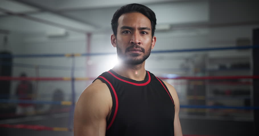 Serious, sports and face of man boxer in gym for competition practice, match or workout for conditioning. Pride, confident and portrait of fighting champion from Mexico in ring for fitness training.