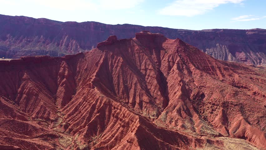 Sunlight illuminating rugged red sandstone canyon reveals vibrant landscape filled with colorful rock formations. Aerial view beauty of erosion and geological layers in the southwest usa