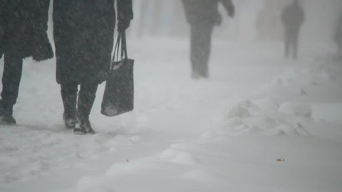 people walk on snowy road
