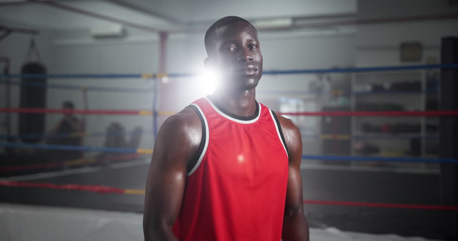 Crossed arms, sports and face of black man boxer in gym for competition practice, match or workout. Serious, confident and portrait of male fighting champion from Nigeria for fitness training.