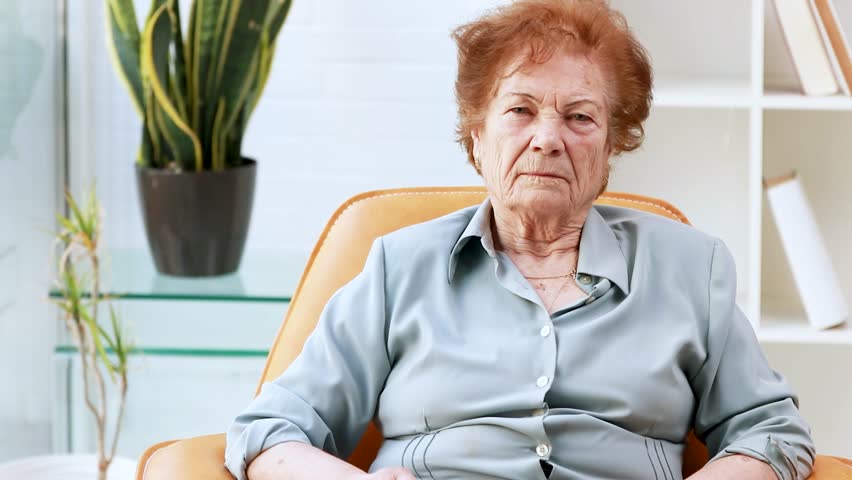 senior woman with fan at home in summer