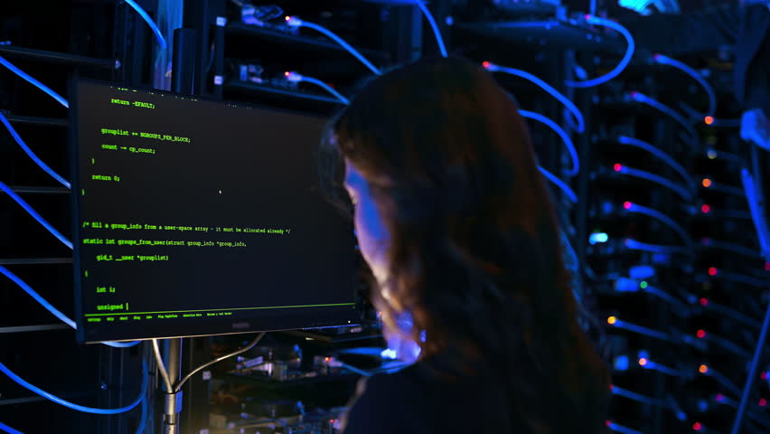 Woman programming in a server room