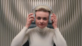 Happy smiling woman Caucasian girl lady female businesswoman influencer gamer in futuristic gaming cyberspace sci-fi relaxing listen music in headphones mobile phone audio earphones showing thumb up - Powered by Shutterstock - Get 15% off with code: PIKWIZARD15