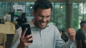 Male customer visitor tourist in cafe restaurant happy cheerful amazing Indian Arabian businessman ethnic business man guy worker read mobile phone message rejoice celebrate win online bet gambling - Powered by Shutterstock - Get 15% off with code: PIKWIZARD15