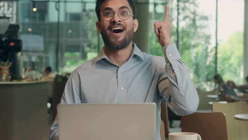 Indian businessman thoughtful thinking Arabian man guy freelance worker business client in cafe restaurant happy joyful smiling entrepreneur online work laptop create idea inspiration plan find answer