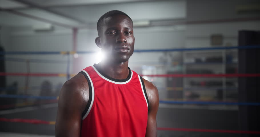 Serious, sports and face of black man boxer in gym for competition practice, match or workout for conditioning. Pride, confident and portrait of fighting champion from Nigeria for fitness training.