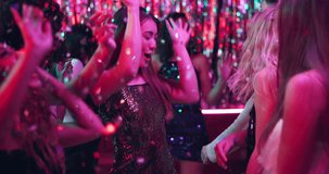 Dancing, friends and night with women in club for new years eve party, celebration and concert. Neon, energy and music with people at confetti disco for freedom, social event and festival together - Powered by Shutterstock - Get 15% off with code: PIKWIZARD15