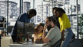 Programmers gathered together to conduct code review to fix errors, identifying technical issues with company software. Team of developers doing brainstorming, optimizing code, camera B - Powered by Shutterstock - Get 15% off with code: PIKWIZARD15