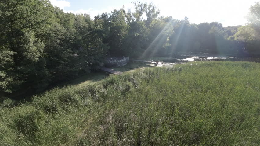 The video begins with a tranquil scene of a park. The lush green trees and the bright blue sky create a serene atmosphere. The parks peaceful ambiance is further enhanced by the gentle sound of birds