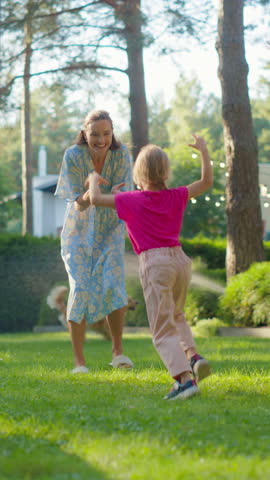 Vertical Screen: Family Enjoying a Day Playing Games with Kids and Golden Retrievers in the Garden Behind the House. Laughter and Fun Fill the Air as Two Daughters and Parents Run and Play Outdoors
