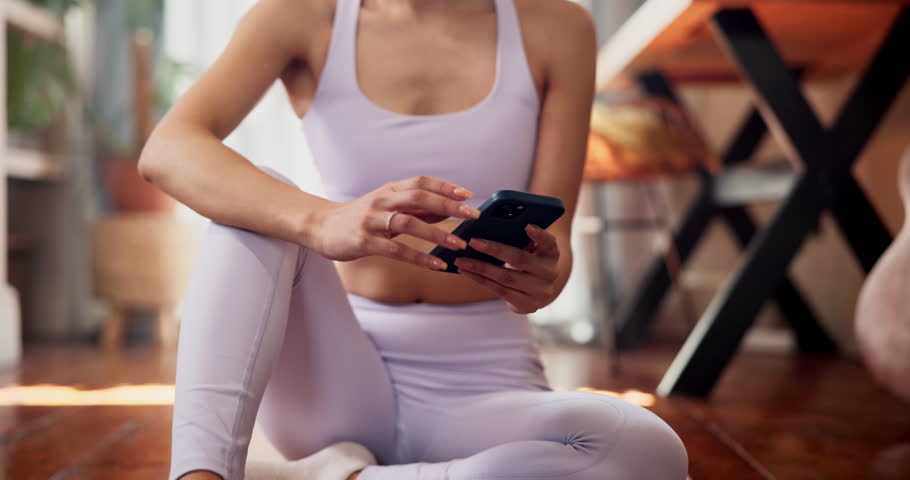 Woman, hands and yoga with phone for tutorial, online browsing or tips on exercise at home. Closeup, female person or yogi typing with mobile smartphone for fitness app, research or health benefits