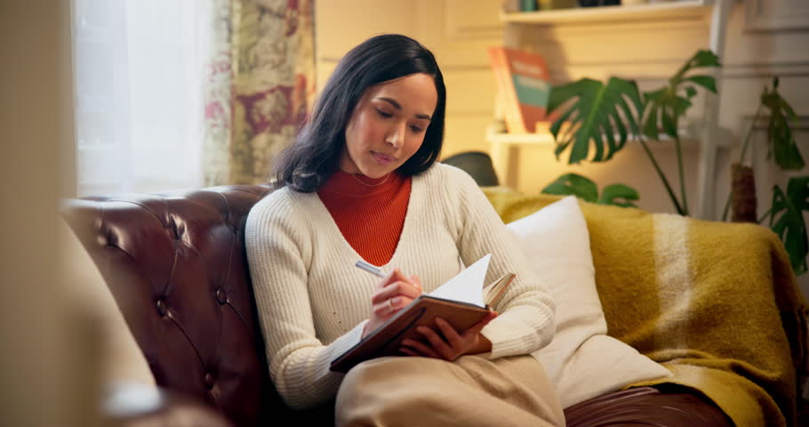 Woman, writing and book for thoughts in home, gratitude journal and notes for reflection on dream. Female person, relax and diary for inspiration in lounge, planning goals and vision for opportunity