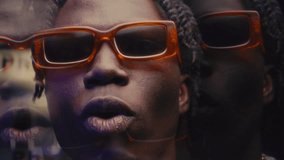 Kaleidoscopic effect of expressive Black rapper with dreadlocks wearing trendy orange sunglasses and gold chain necklace gesturing and performing hip-hop song on camera - Powered by Shutterstock - Get 15% off with code: PIKWIZARD15