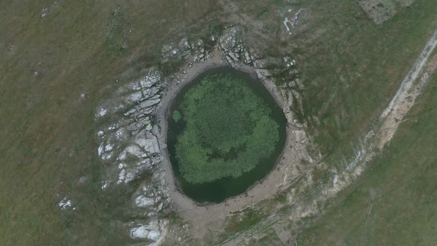 Drone flying over mountain range with sinkholes and other karst relief. Early morning before sunrise flight. Natural landscape