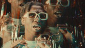 Black hip-hop performer rapping to camera from behind shiny tinsel curtain in pulsating neon lights of nightclub. Kaleidoscopic effect - Powered by Shutterstock - Get 15% off with code: PIKWIZARD15