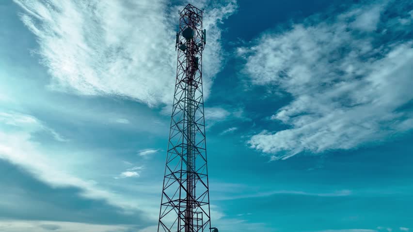 Drone Flying around the cellular tower with blue sky Background. Telecom Tower Antennas Transmitting 4G 5G Signals to Rural Areas: Aerial Perspective. Showcasing the critical role of antenna