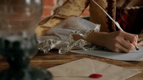 Antique young woman in renaissance dress sitting at table and writing letter with vintage quill pen with ink on old parchment papers sheet, close up shot. - Powered by Shutterstock - Get 15% off with code: PIKWIZARD15
