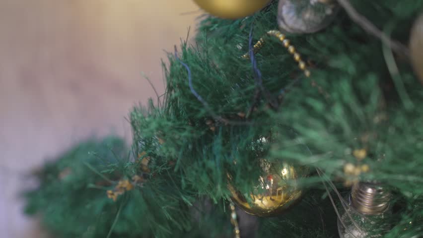 Spraying artificial snow on a decorated Christmas tree