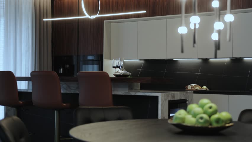 The modern kitchen interior features a beautiful dining area complemented by elegant lighting