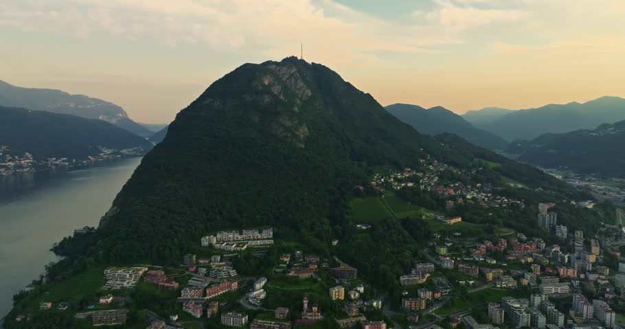 Aerial view of Lugano city and lugano lake from San Salvatore mountain. Aerial footage of the Monte Bre overlooking the city of Lugano in Canton Ticino in Switzerland