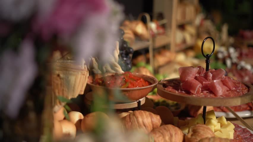 Assorted cheeses and hams on a tasting table at a luxury party